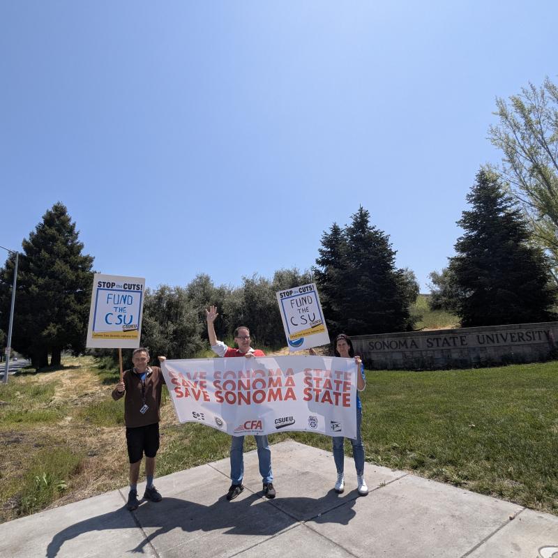 Three people with signs, Save Sonoma State and 2 with Fund the CSU